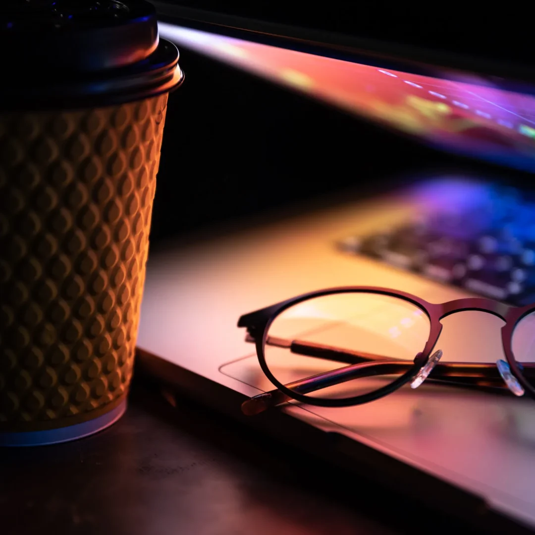 laptop-half-closed-dark-with-colourful-glow-cup-coffee-glasses-scaled laptop-half-closed-dark-with-colourful-glow-cup-coffee-glasses-scaled